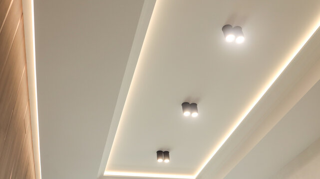 modern ceiling design with recessed lighting and decorative wooden paneling