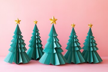 Five teal colored three dimensional holiday trees with gold stars adorn a soft pink background