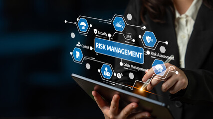 A business professional uses a tablet to engage with interactive risk management technology, showcasing essential elements for strategic decision-making and analysis. Tessel
