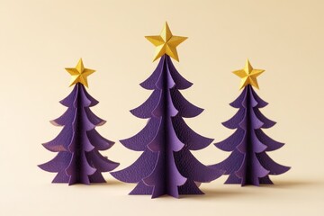 Three dimensional stylized evergreen decorations topped with golden stars are arranged on a pale background