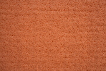 orange sponge texture close up, pink abstract sponge texture as background photo on top	

