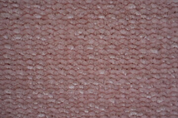 Fototapeta premium pink Soft plush fabric texture, close-up macro view of soft plush fabric with a warm, fuzzy surface. The detailed texture shows dense fibers and a gentle, velvety feel commonly used in blankets, cloth