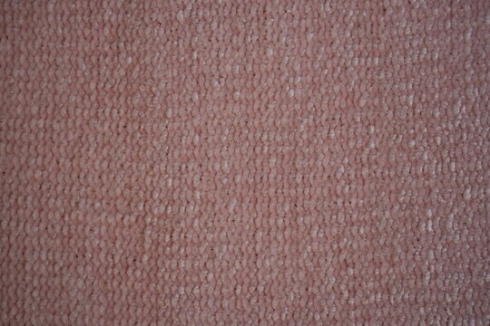 pink Soft plush fabric texture, close-up macro view of soft plush fabric with a warm, fuzzy surface. The detailed texture shows dense fibers and a gentle, velvety feel commonly used in blankets, cloth