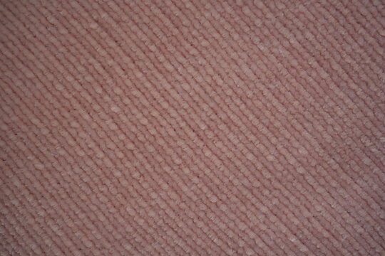 pink Soft plush fabric texture, close-up macro view of soft plush fabric with a warm, fuzzy surface. The detailed texture shows dense fibers and a gentle, velvety feel commonly used in blankets, cloth