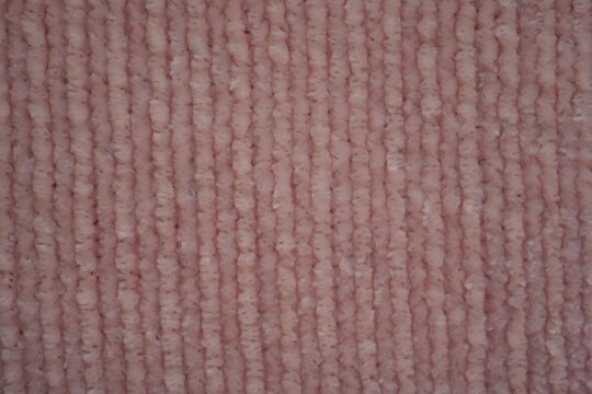 pink Soft plush fabric texture, close-up macro view of soft plush fabric with a warm, fuzzy surface. The detailed texture shows dense fibers and a gentle, velvety feel commonly used in blankets, cloth