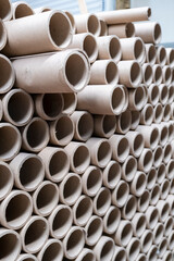 Close up view of stack of cylindrical cardboard tubes.