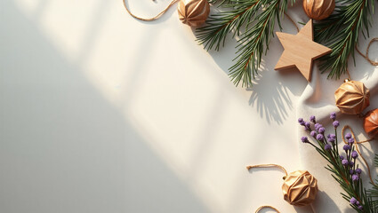 Green fir branches and wooden decorations on light background