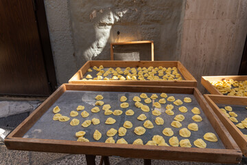 Handmade orecchiette pasta at a street market in Bari, Italy.