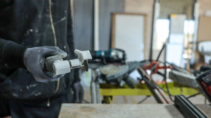 A worker using a small rotary tool in a workshop setting