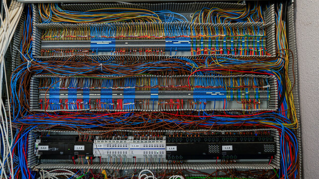 Complex electrical wiring and control panel with numerous colorful cables