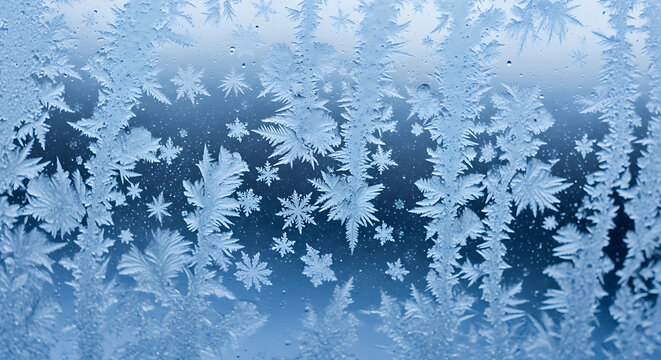 Frost crystals forming intricate patterns on a cold window in winter.