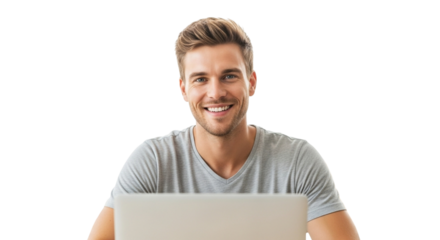Smiling man in a grey tshirt sitting at a laptop, looking directly at the camera isolated on transparent background