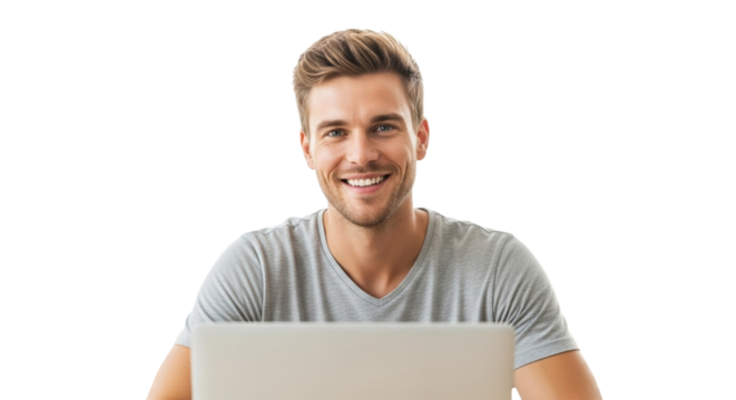 Smiling man in a grey tshirt sitting at a laptop, looking directly at the camera isolated on transparent background