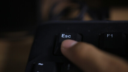 Finger on Esc key — escape and cancel command on computer keyboard (macro)