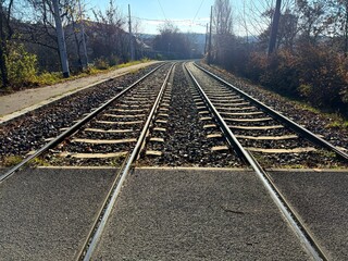 People and automobile asphalt crossing over rails
