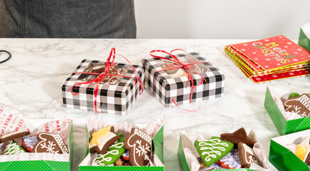 Person Wrapping Holiday Cookie Gift Box with Festive Packaging