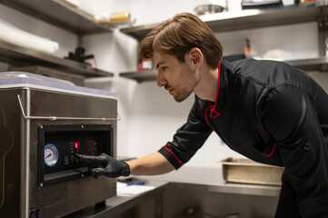 Fototapeta premium Professional cook engaged in food preparation process