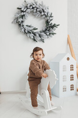 little boy playing with a toy house