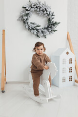 Child swinging on a rocking horse on a white background