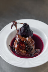 Braised lamb shank or duck leg with sauce and topinambur chips garnish