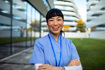 Adult nurse smiling confidently outside modern hospital