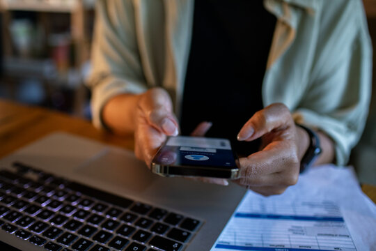 Focused adult making mobile payment at home office