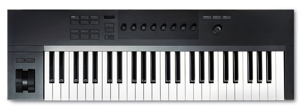 Black Synthesizer or MIDI controller keyboard is shown, featuring keys, knobs, and control buttons isolated on white background, Keyboard on White Background With clipping path.