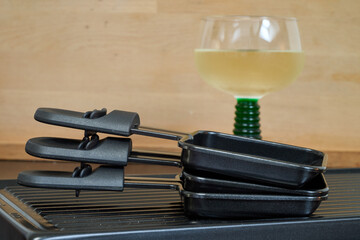 Raclette trays and wooden pallets on table