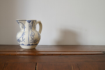 old Delft  milk jug on a piece of furniture