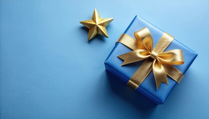 Unwrapping joy a gift box with golden bow and star on blue background celebratory atmosphere artistic presentation close-up view festive concept for special occasions
