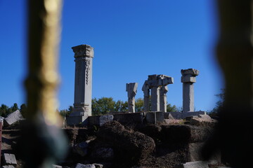 Standing Witness to Time-This image captures the enduring presence of ancient columns against a clear blue sky. The ruins, once part of a grand structure, now stand as silent witnesses to the passage.