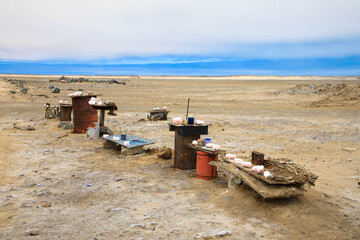 Salt crystals on sale at makeshift roadside tables, with honesty boxes to collect money, Cape Cross, Skeleton Coast, Namibia
