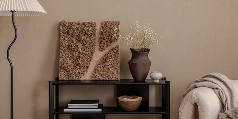 Minimalist interior with sculptural wall art, ceramic vase, and soft beige accents in a cozy modern living space.