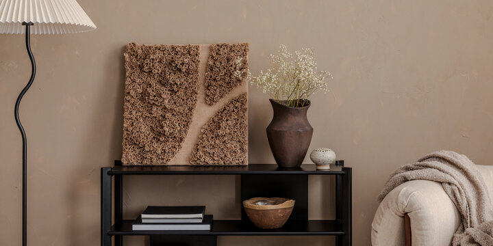 Naklejki Minimalist interior with sculptural wall art, ceramic vase, and soft beige accents in a cozy modern living space.