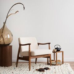 Interior design of aesthetic and minimalist living room with boucle armchair, wooden coffee table,...