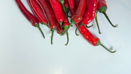 close-up video of Mexico or Chile peppers displayed on  a white background. This footage highlights the vibrant colors and textures of the peppers, ideal for culinary, retail. Fresh Peppers.