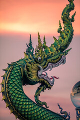 Fototapeta premium Background of Thailand's Chonburi religious attractions (Wat Khao Phra Khru viewpoint), with beautiful Buddha and Phaya Naga statues, tourists always come to make merit and take pictures at night.