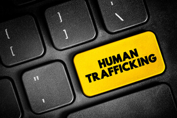 Naklejka premium Human Trafficking is the trade of humans for the purpose of forced labour, text button on keyboard, concept background