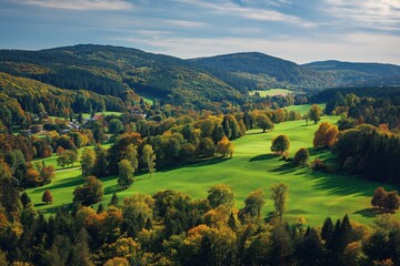 Bird's-eye view of serene autumn landscape with meadow, forest foliage, and distant golf course, perfect for outdoor branding projects.