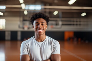 Teen boy smiling confidently in a basketball gym
