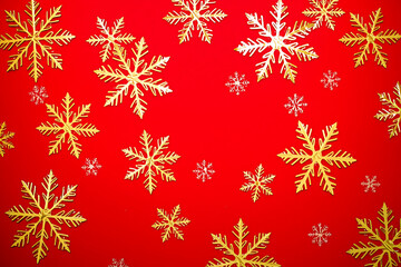 A decorative Christmas-themed design with a mix of gold and white snowflakes arranged on a bold red background. Ideal for greeting cards, banners, invitations, packaging, print templates, and seasonal