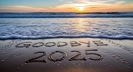 Goodbye written in sand on beach at sunset with ocean waves