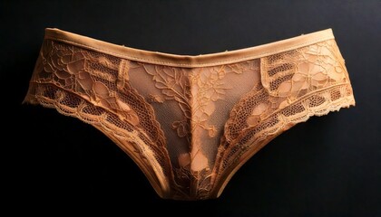 Elegant peach lace lingerie isolated on black.