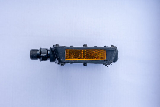 Bicycle pedal with yellow reflector, close-up, typical pedal for road and city bikes