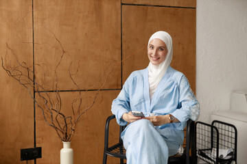 Muslim woman in a hijab with a mobile phone	
