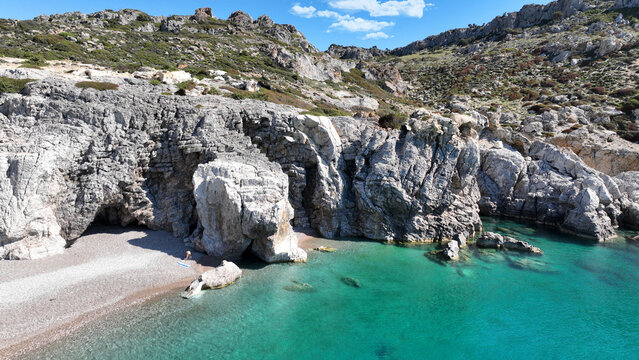 Aerial drone photo of beautiful beach of Traganou with amazing sea caves and turquoise crystal clear sea next to massive popular beach of Afantou, Rhodes island, Dodecanese, Greece