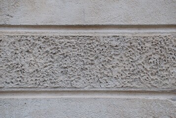 High-resolution close-up of a rough stucco plaster wall texture, showing granular, weathered surface details ideal for architectural, construction, background, or material design use.