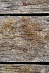 High-resolution weathered wood texture featuring rugged grain, earthy tones, and natural organic detail. Ideal for backgrounds, design projects, rustic themes, and nature-inspired visual compositions.