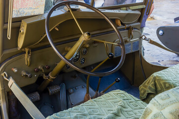 Vintage Military Jeep Interior With Steering Wheel And Gear Levers In Olive Drab