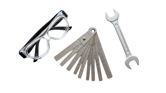 Set of Automotive Repair Tools Including Safety Glasses a Feeler Gauge Set and a Wrench on a Transparent Background